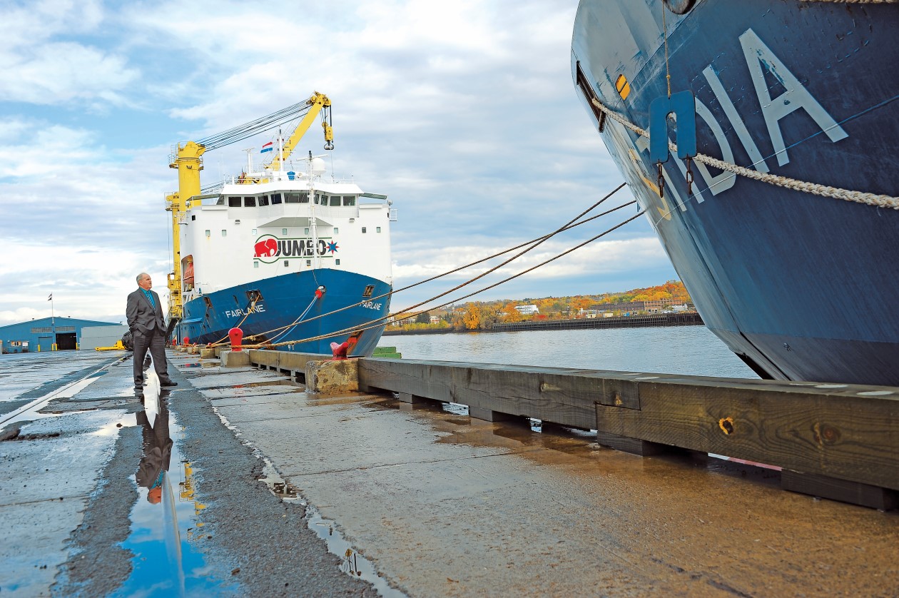 Ships along dock with Port CEO in middleground