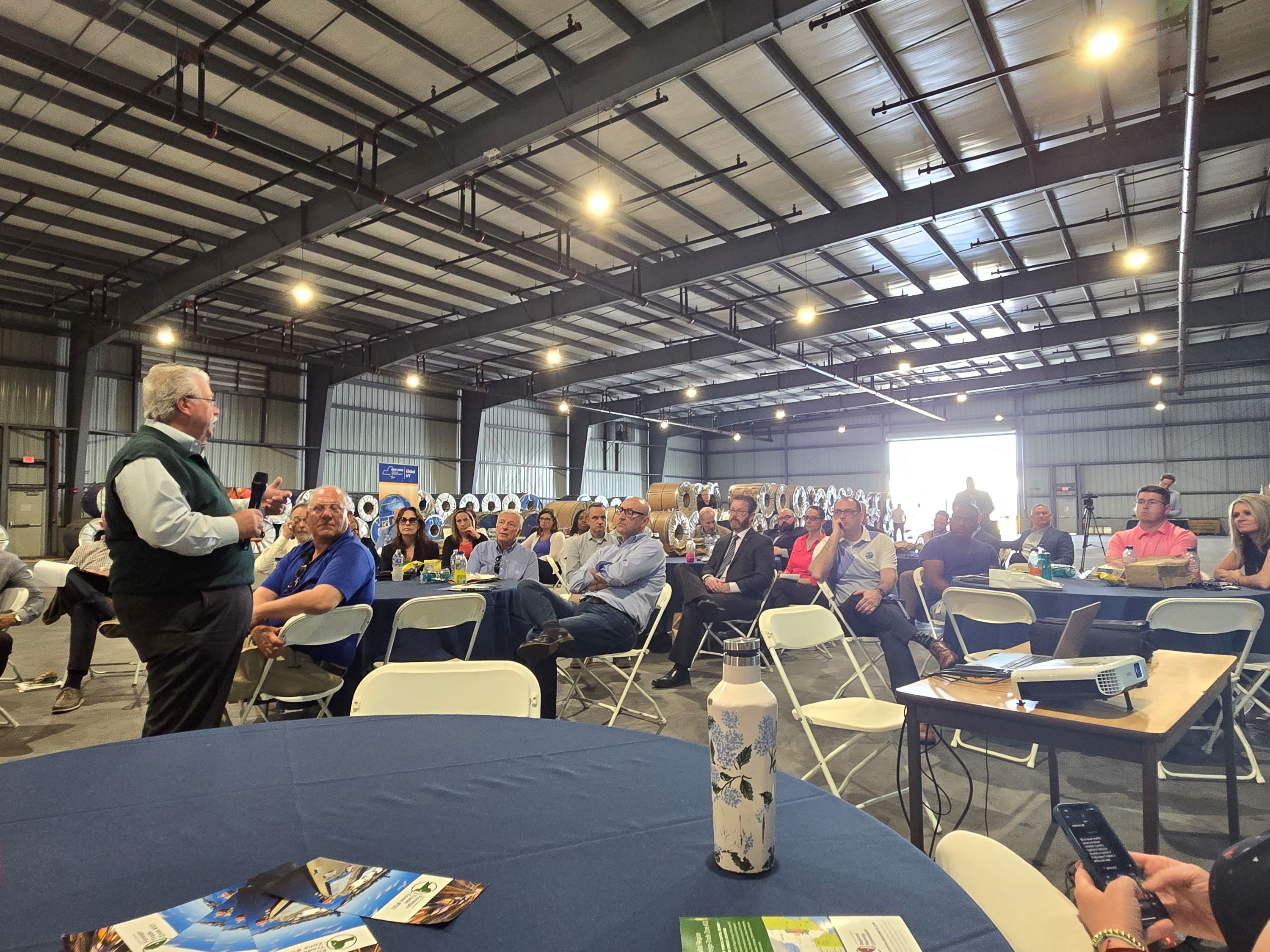 A celebration inside the completed warehouse, with various tables and a speaker