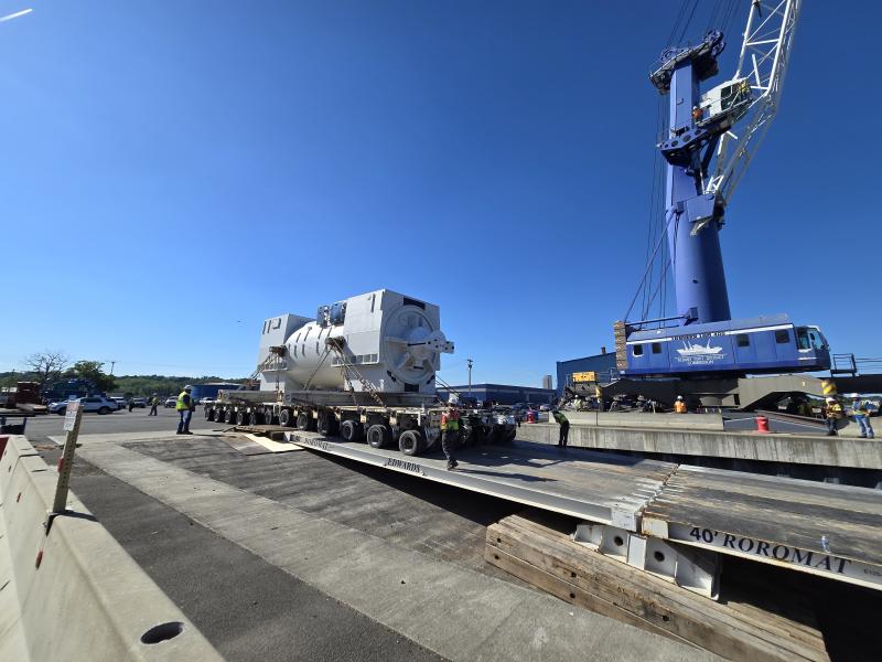 Huge generator loading on to barge via RO/RO with crane in the background