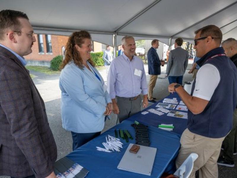 Attendees interacting at Expo table