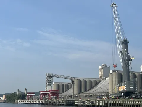 Harbor crane with Ardent Mills and red grain hoppers as viewed from the river 