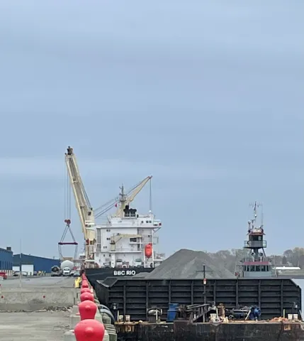 Along the dock with a ship unloading in the background