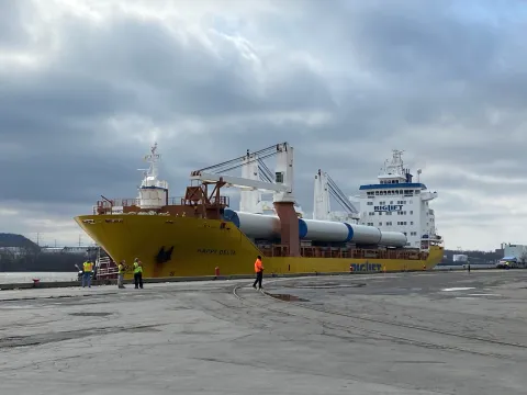 Ship, Happy Delta, with a yellow hull, at the dock