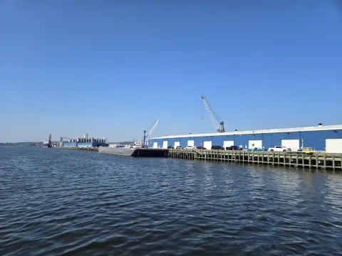 Sheds #4 and #5 as seen from the water with cranes in the background 