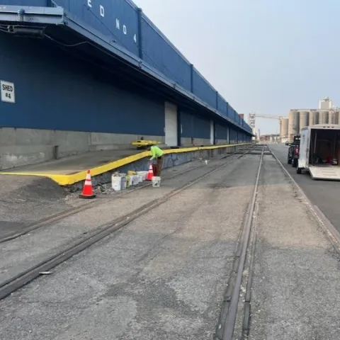 Worker adjacent from SDVOB company adjacent to concrete renovation to loading docks