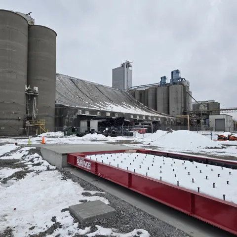 truck scale under construction (covered in snow) with Ardent Milling and silos in background