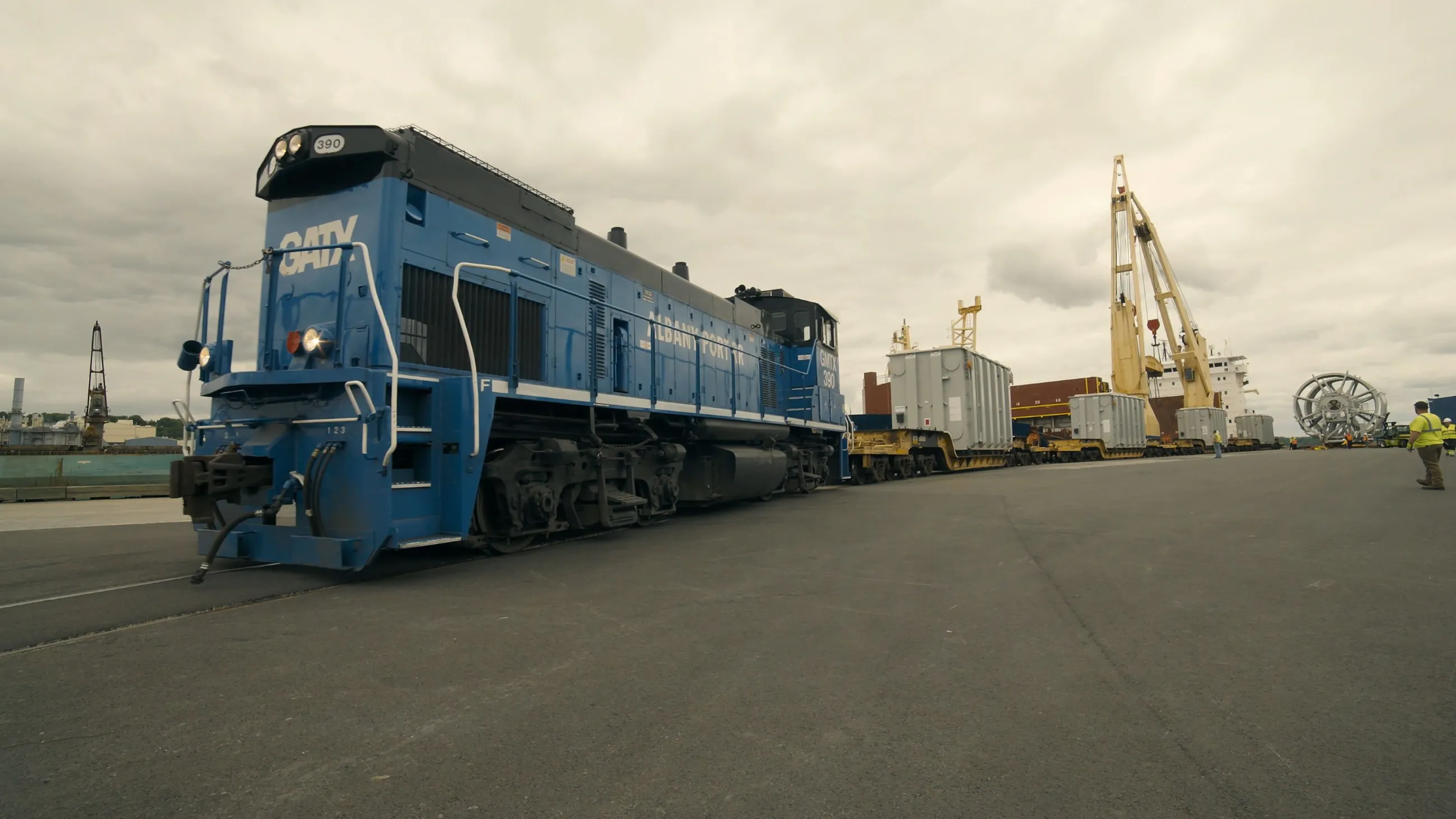 Albany Port Railroad blue train engine pulling cargo