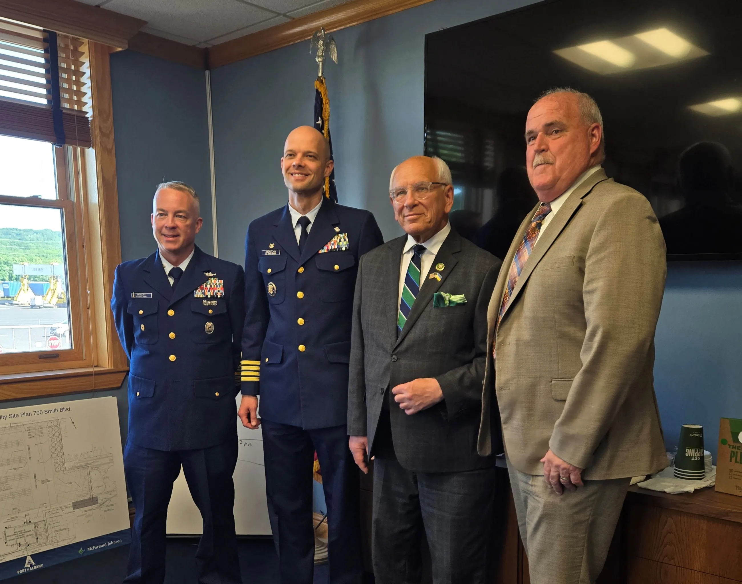 Coast Guard, a congressman, and the Port CEO stand together in a conference room