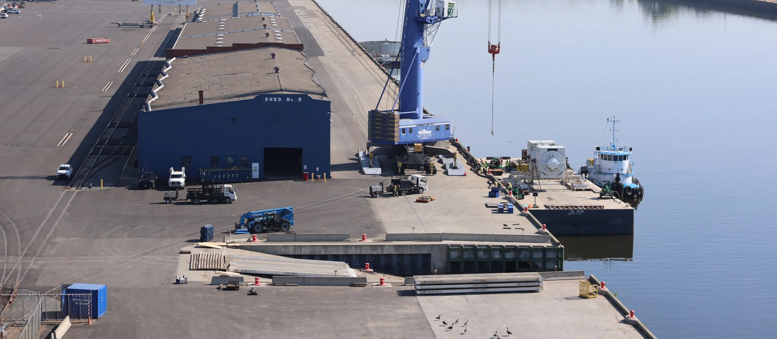 Port of Albany dock seen overhead from a drone with a wharf, shed, and crane visible