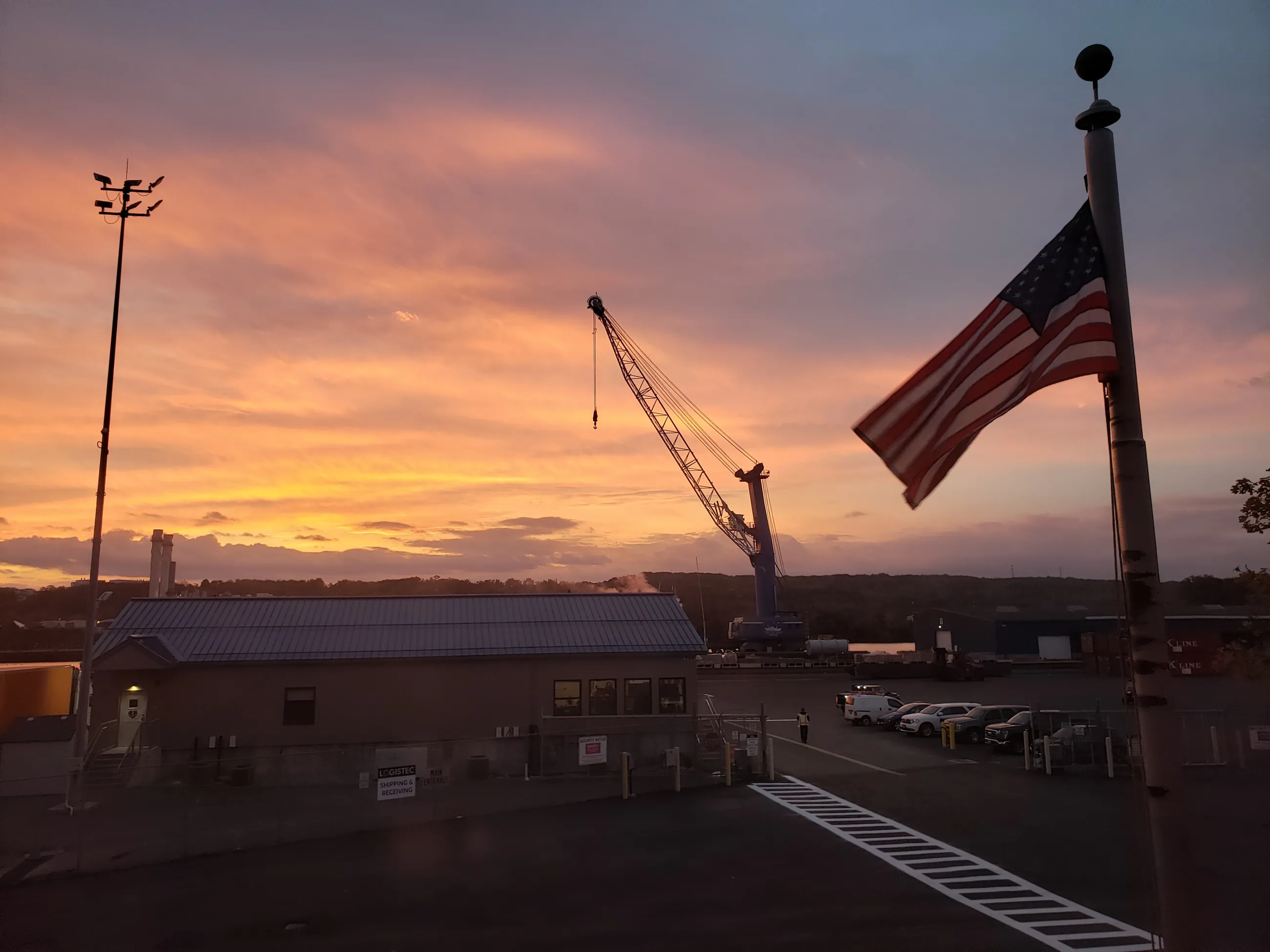 Looking out at Port terminal at dawn with flag in foreground